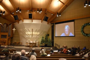 Grace speaking over Zoom at the convening 