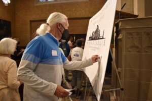 An attendee posting their response onto the card.