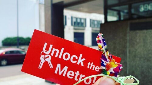 Colorful keys with a tag that reads "Unlock the Metro" outside of the Met Council building