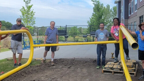 Team of volunteers constructing playground
